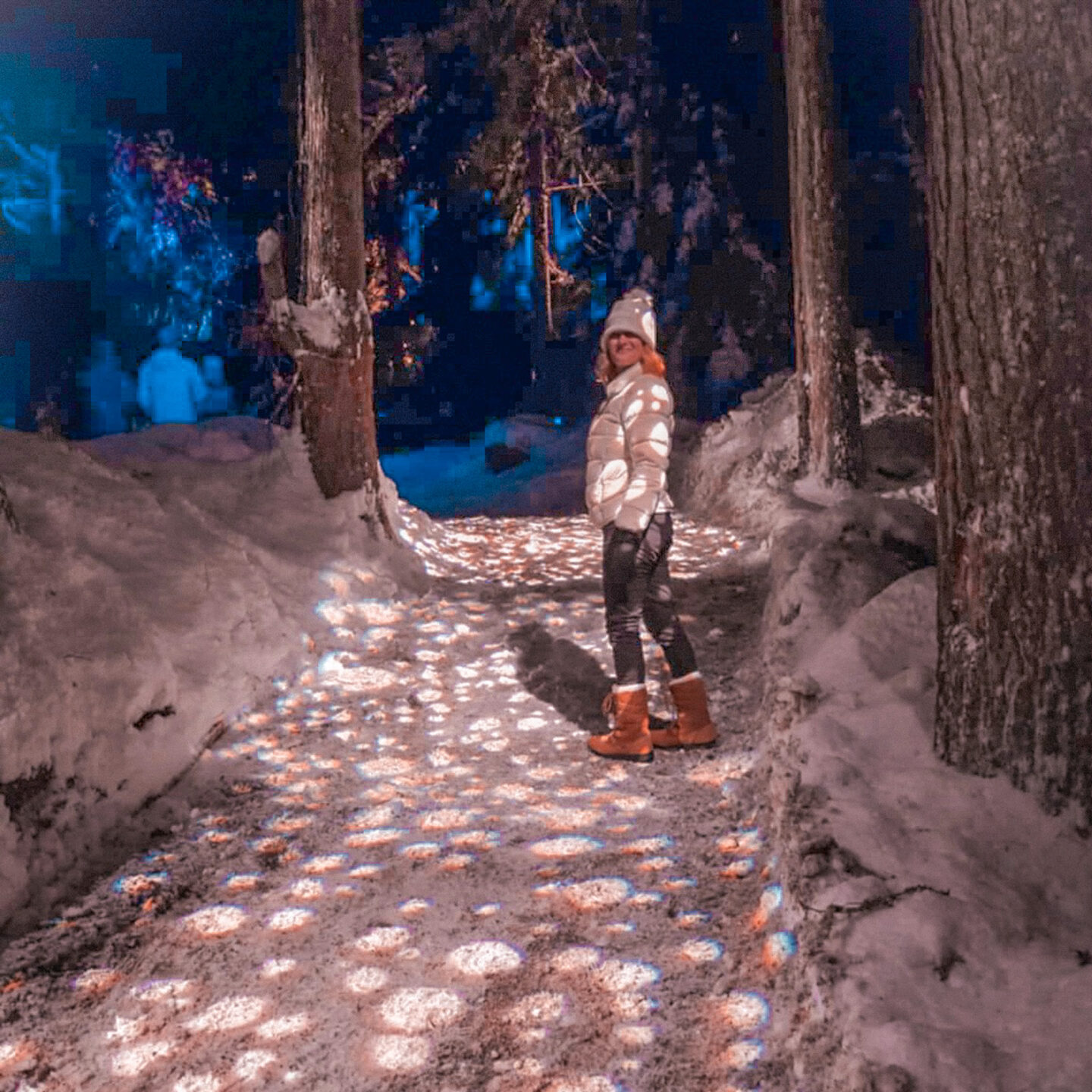 Glowing lights and snow-covered trees along the Vallea Lumina nighttime forest walk on our 48 hours in Whistler trip.