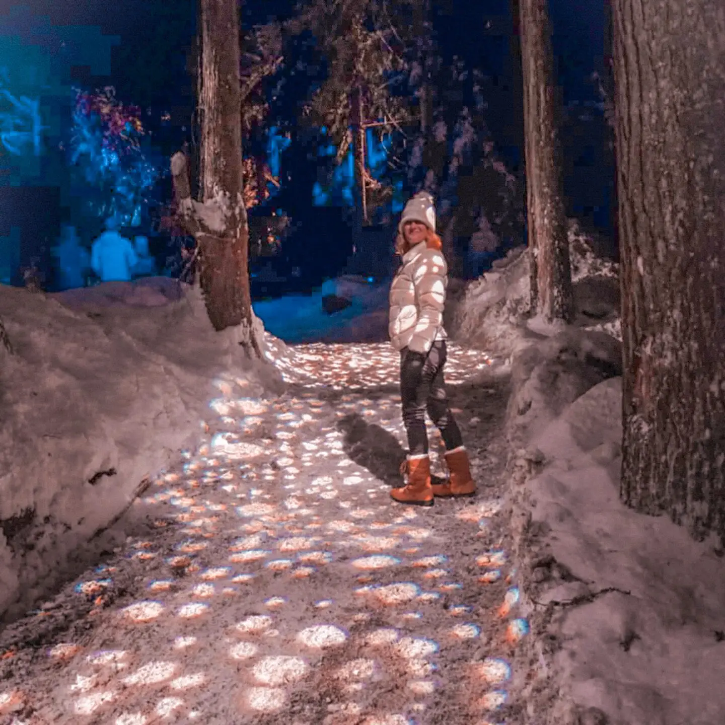 Glowing lights and snow-covered trees along the Vallea Lumina nighttime forest walk on our 48 hours in Whistler trip.