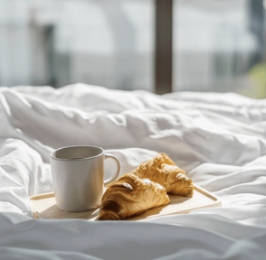 Croissant on hotel bed