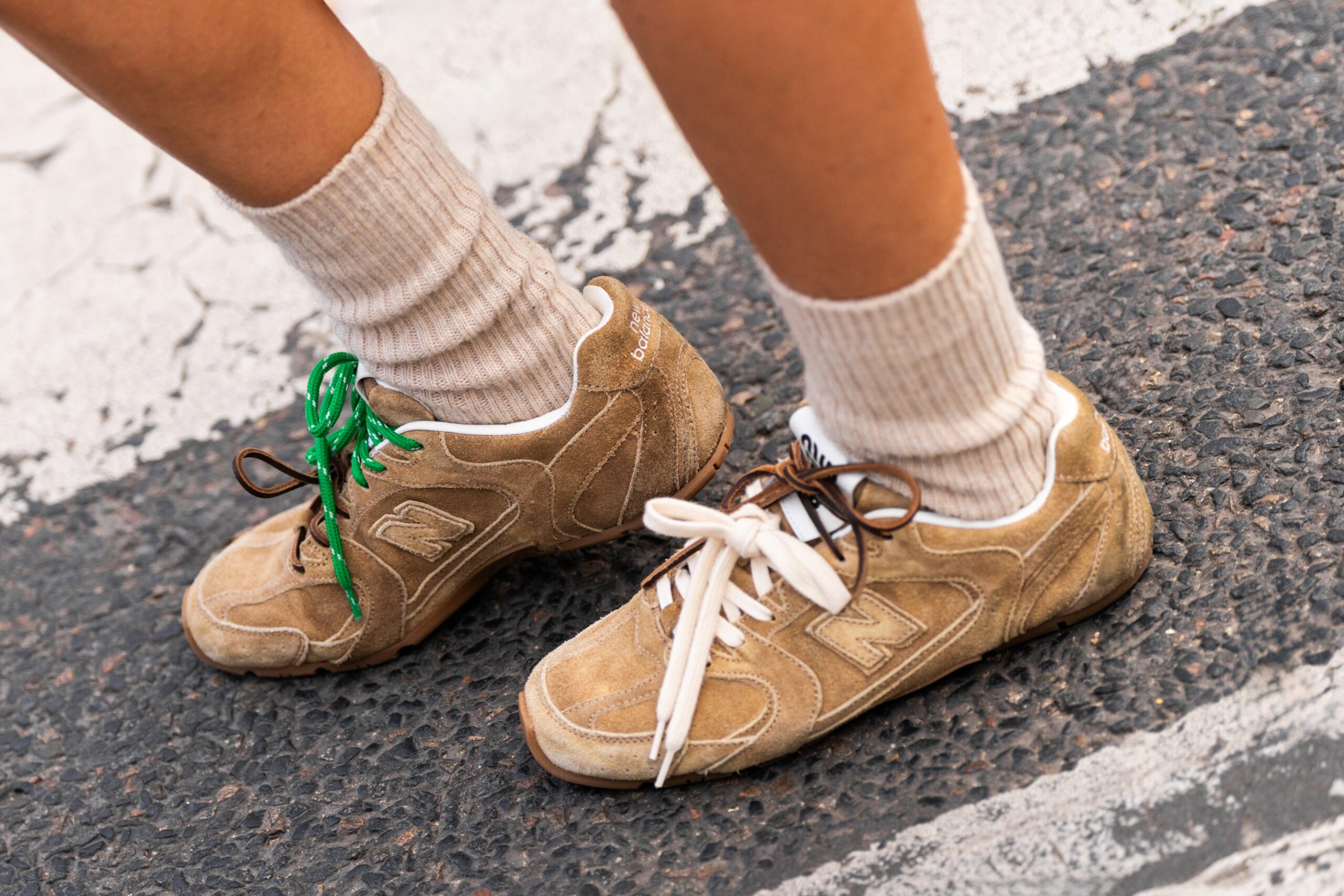 Image of feet with on trend sneakers in paris with colourful laces.