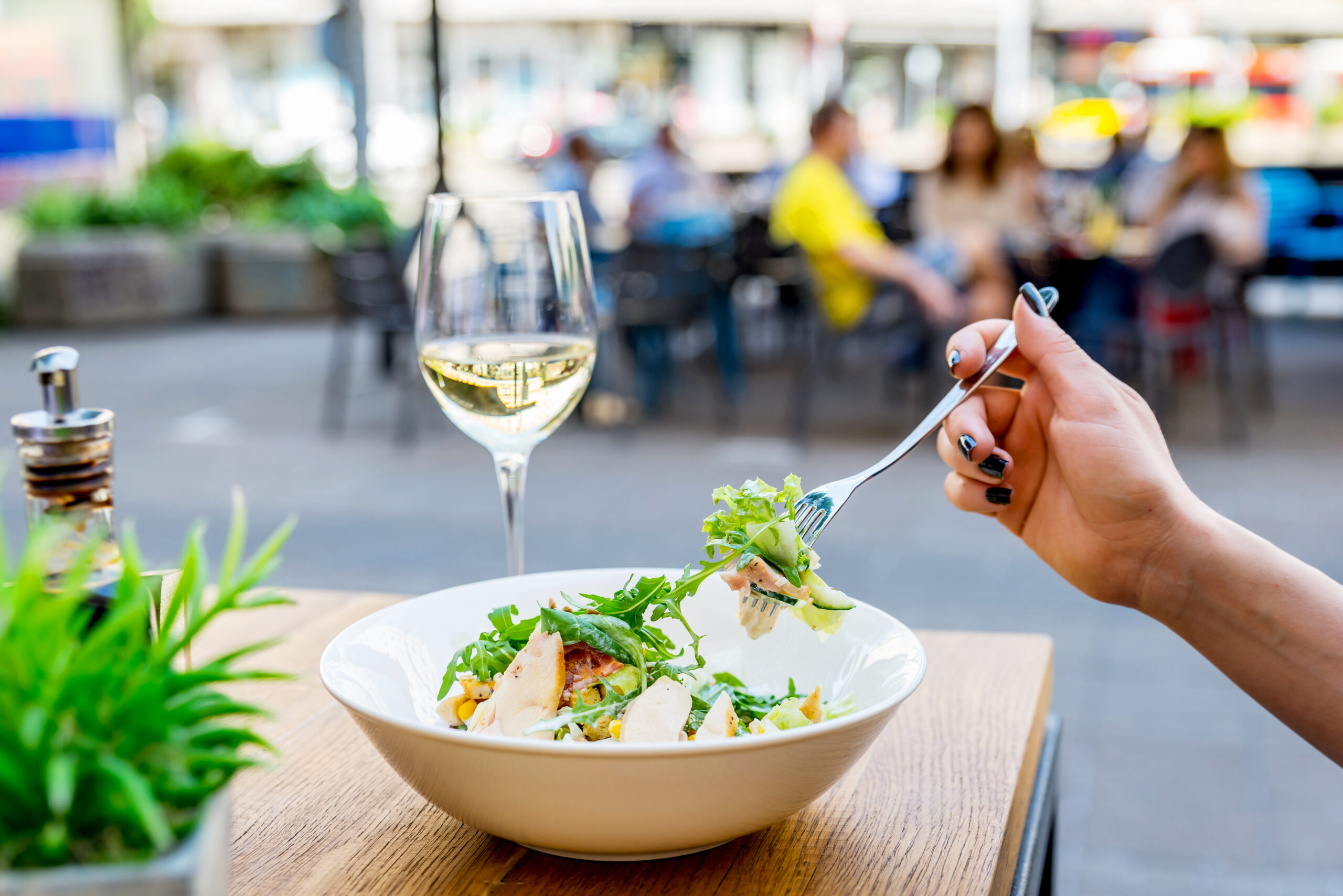 Woman eating a chicken salad solo.