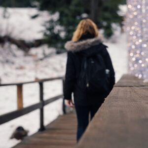 Nicole Strolling along a bridge surrounded by snow.